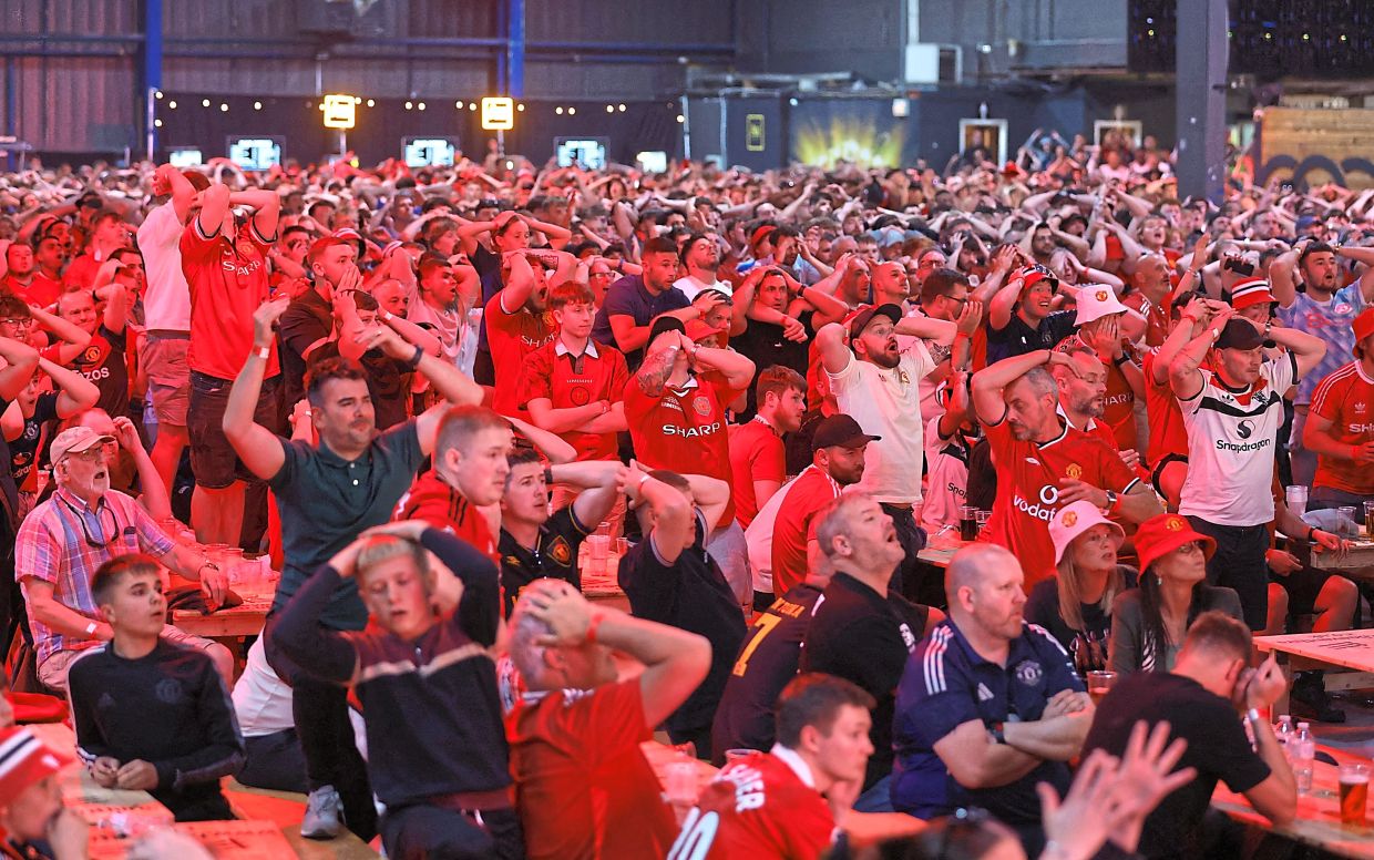 United fans react after Tottenham scored the winning goal. — Reuters