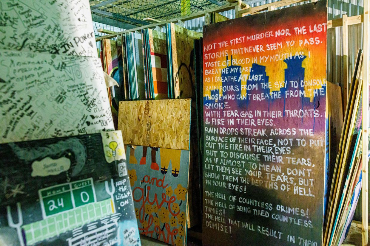 Protest boards painted with poems, tributes, and messages are stored at a Minneapolis warehouse by the nonprofit Save the Boards. Photo: AFP 