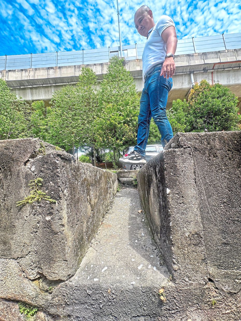 Goh says there have been reports of pedestrians and cyclists using the damaged pavement along Jalan SS12/4 in Subang Jaya tripping and falling into the drain. — Photos: MUHAMAD SHAHRIL ROSLI/The Star