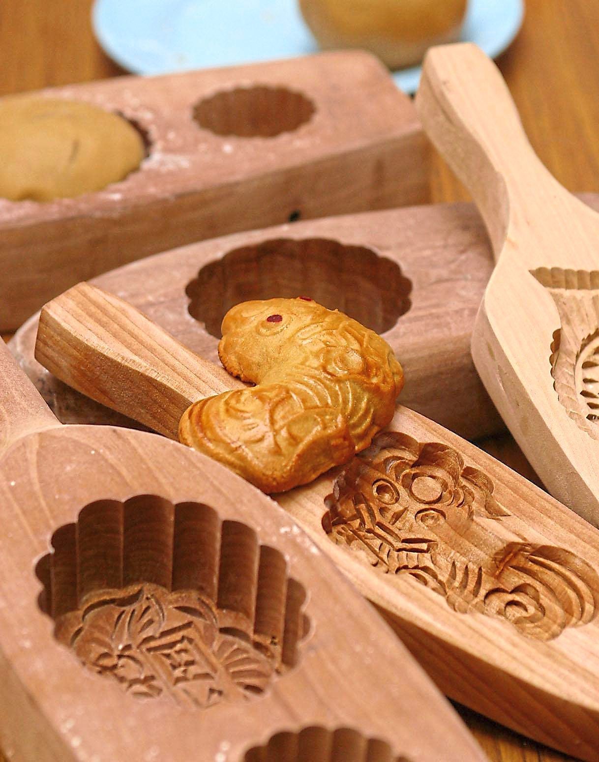 The traditional wooden moulds used for shaping mooncakes are made by hand. — Filepic