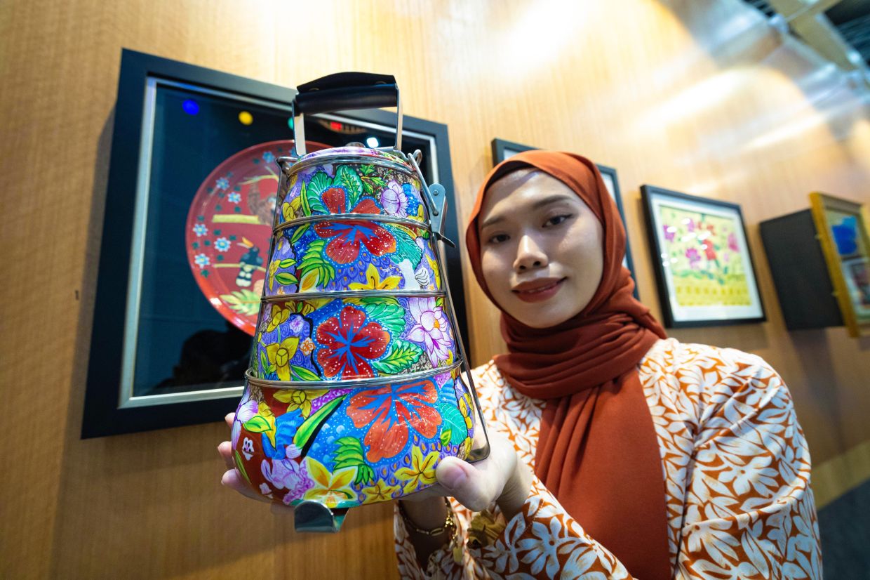 Nur Amiratul’s painted 'mangkuk tingkat' (lunchboxes) have reached the US, Britain, Canada, Qatar, Japan, France, and China. Photo: Bernama 
