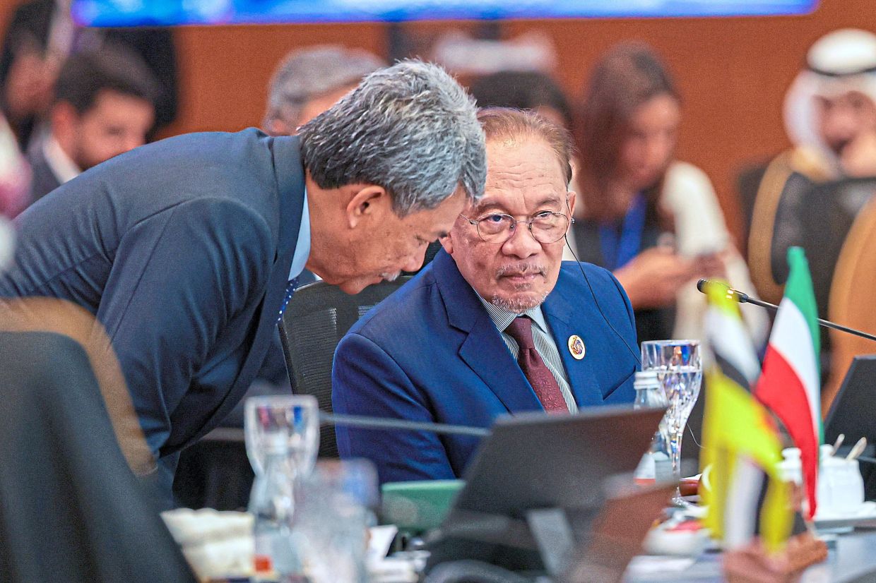 Global outlook: Foreign Minister Datuk Seri Mohamad Hasan having a discussion with Anwar during the Asean-GCC-China Summit at the Kuala Lumpur Convention Centre. — Bernama