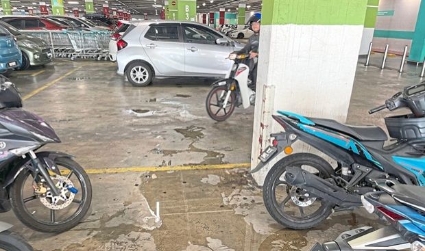Wet floors in indoor parking lots pose risks for motorists.