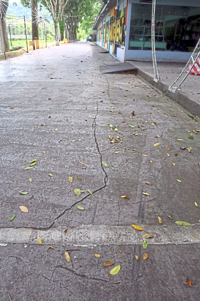Cracks on the walkway near the eateries pose a hazard to visitors.