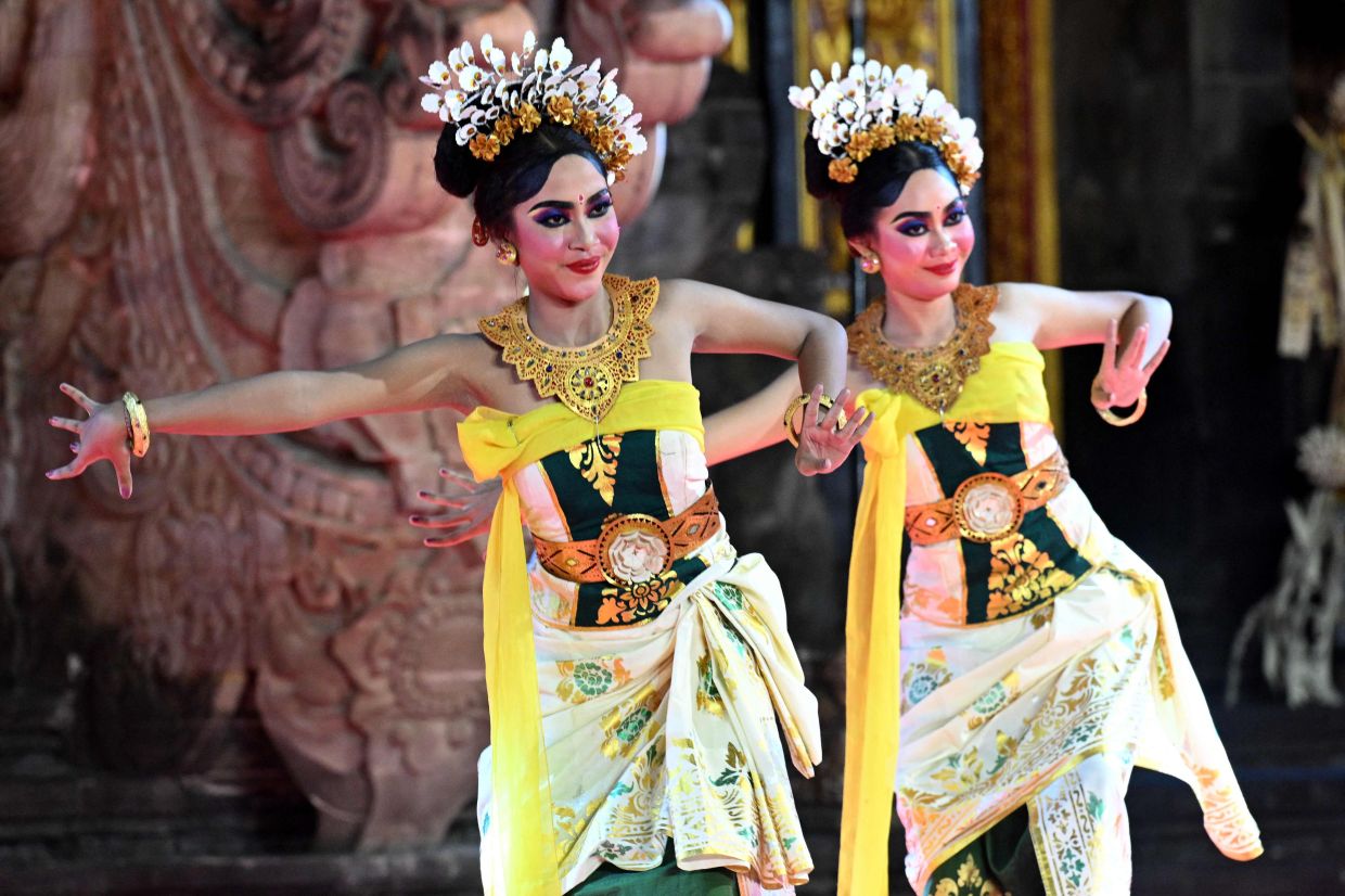 Balinese women perform a traditional dance at Art Center Denpasar on Indonesia's resort island of Bali on Friday, May 30, 2025. -- Photo by SONNY TUMBELAKA / AFP