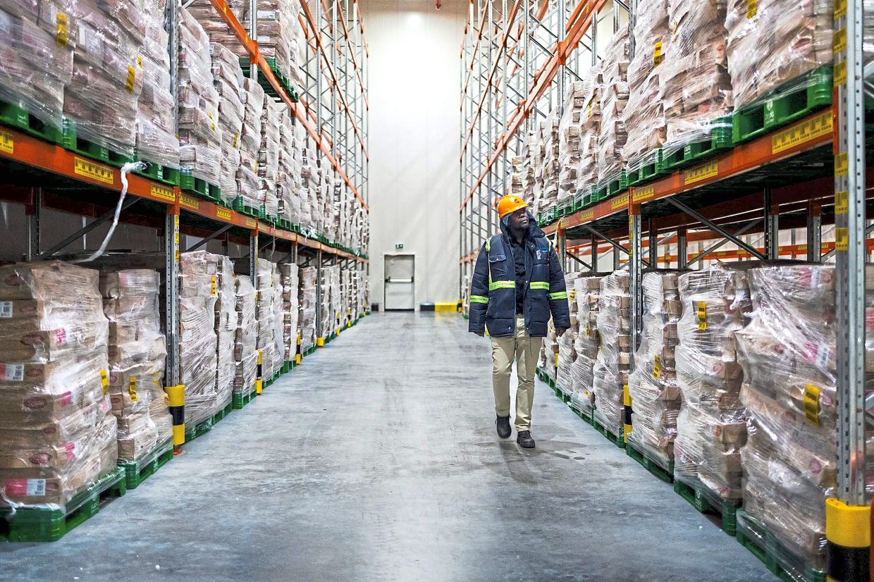 A worker inspecting the condition of goods preserved in sub-zero storage at cold chain solutions provider, Cold Solutions Kenya Sez Ltd, at their plant in Tatu City in Ruiru, Kiambu county. — AFP