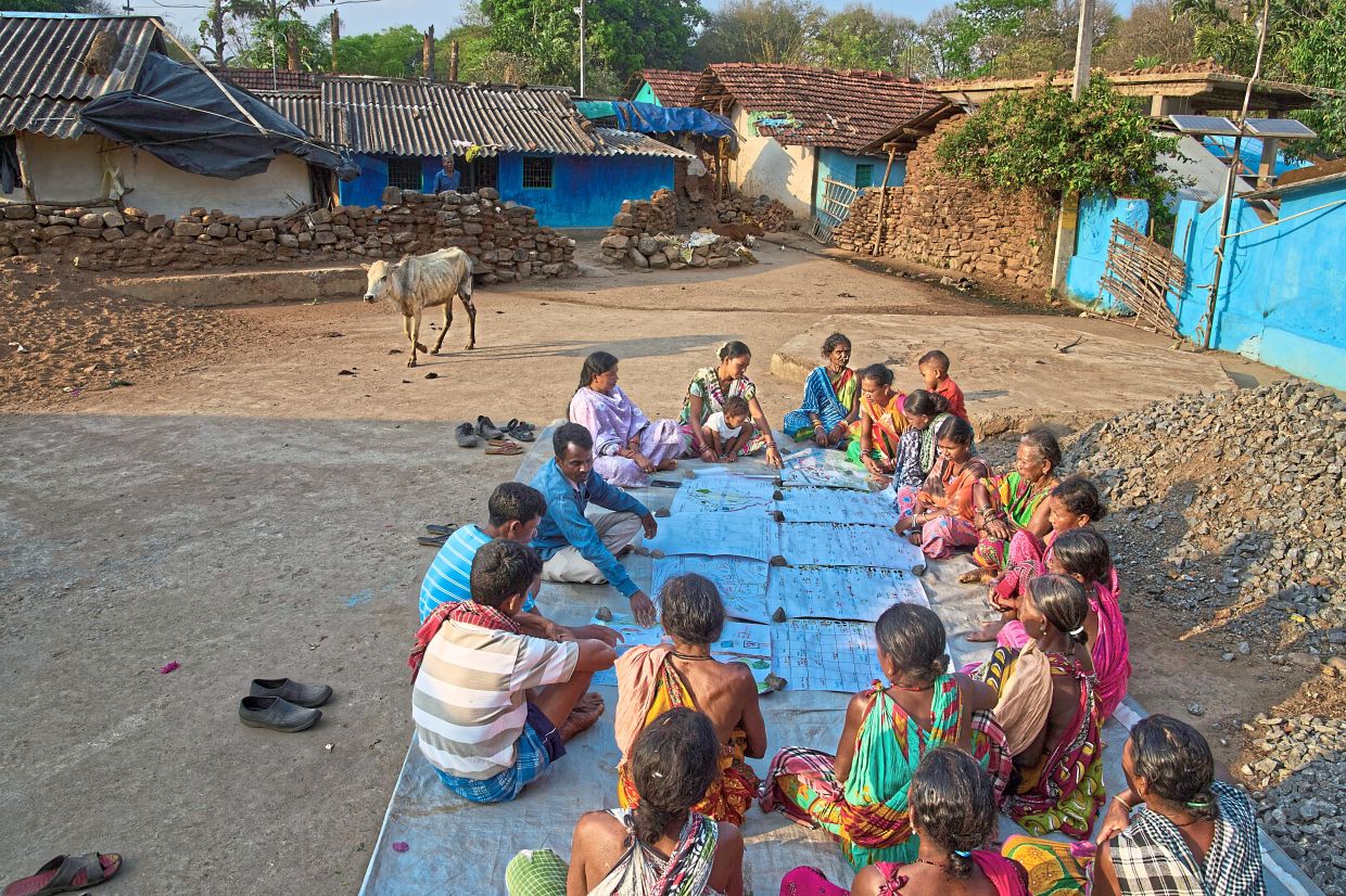 (Right) Members of the Paroja Indigenous community discussing the maps they have made in Hatipakna village, Koraput district. — AP