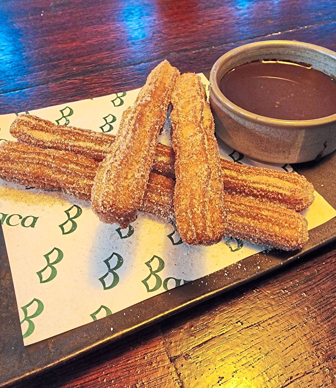 The churros are crisp to the touch and pair perfectly with the chocolate sauce served on the side.