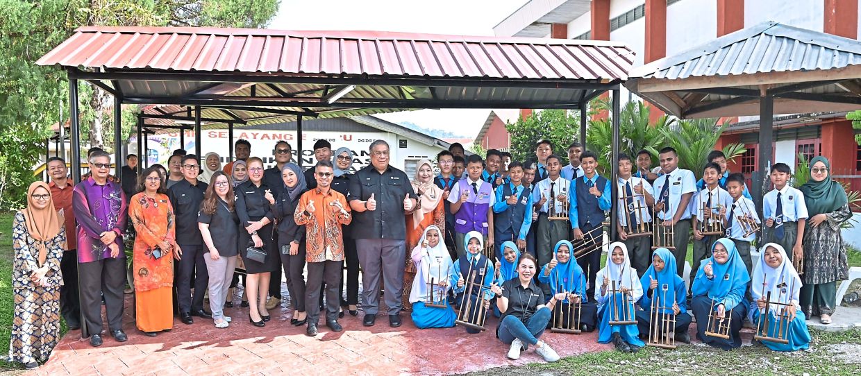 Inclusivity: Nurjesmi and Budiman (front row, eighth and ninth from left) posing for a photo at the school after the launching of the sensory therapy room.