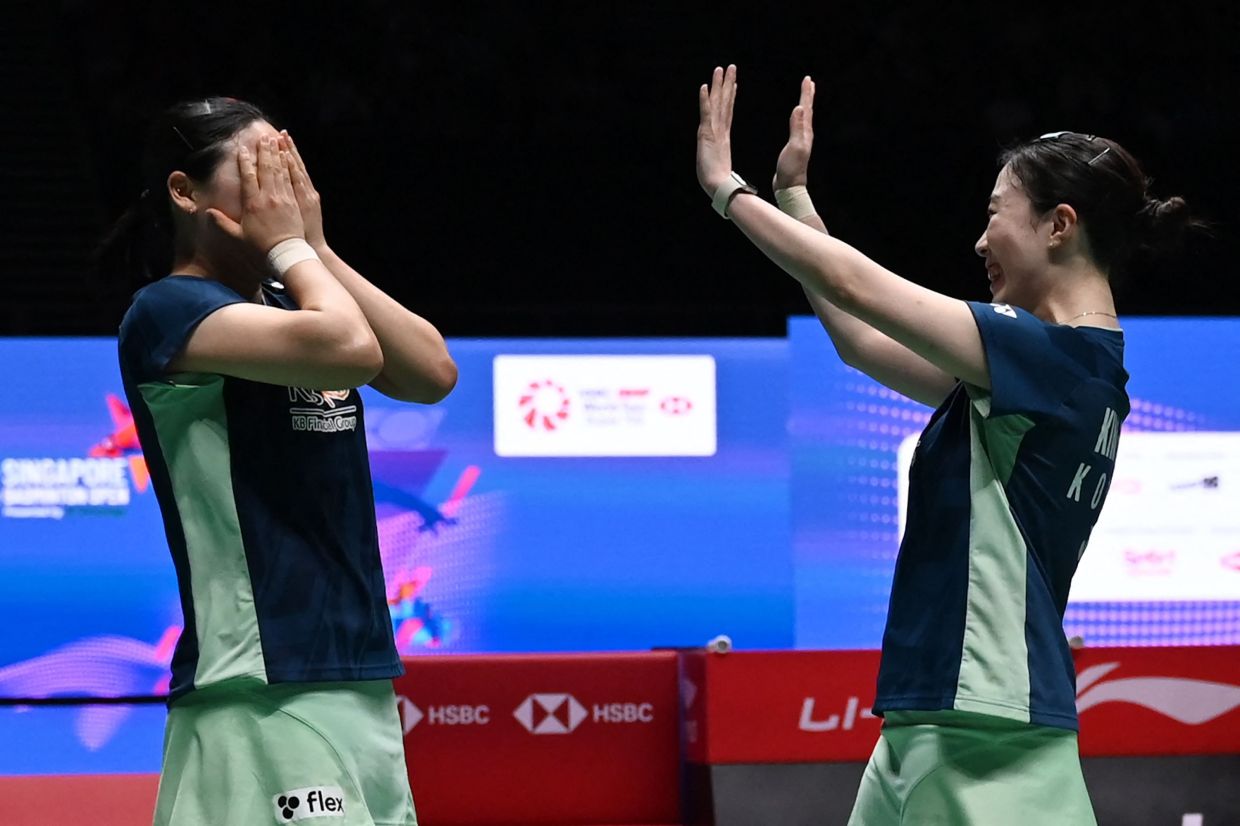 Kim Hye-jeong and Kong Hee-yong of South Korea react after winning the women's doubles final against Rin Iwanaga and Kie Nakanishi of Japan at the Singapore Open badminton tournament in Singapore on Sunday, June 1, 2025. -- Photo by Roslan RAHMAN / AFP