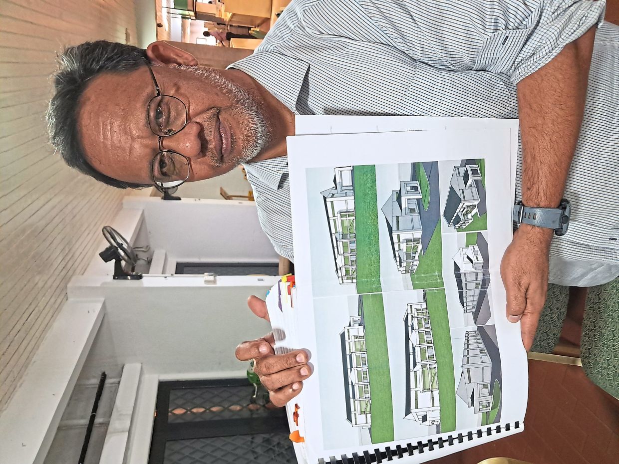 Abdul Aziz showing an artist’s impression of the new school hall.