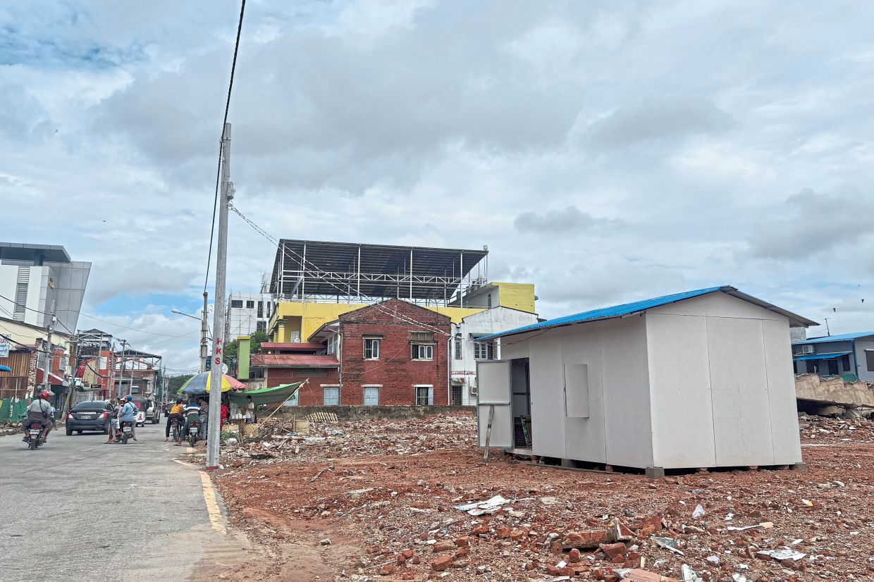 Bit by bit: A temporary structure built over a clearing where an earthquake-affected building once stood, in Naypyidaw. — AP