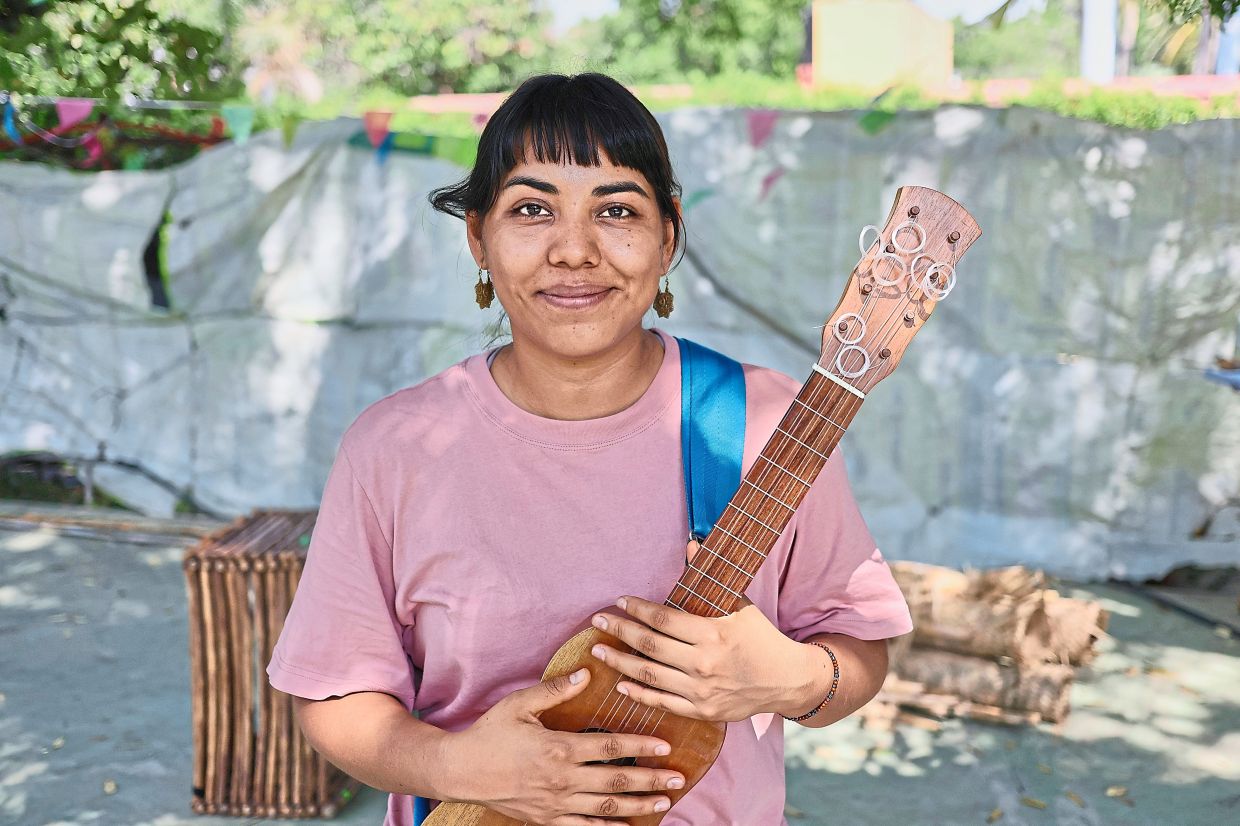 Afro Mexican activist and actress Erendira Castorela poses with her jarana jarocha instrument during a break from a Mulato Teatro rehearsal in Ticuman, Mexico. Photo: AP