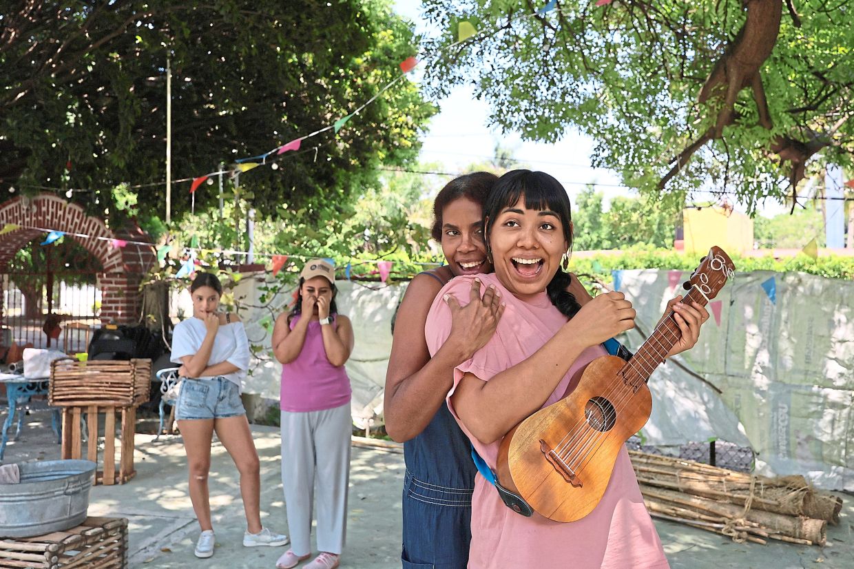 Mulato Teatro cast members Erendira Castorela, strumming a jarana jarocha, and Marisol Castillo, rehearse for their upcoming performance in the First International Afro-Scenic Festival in Ticuman, Mexico. Photo: AP
