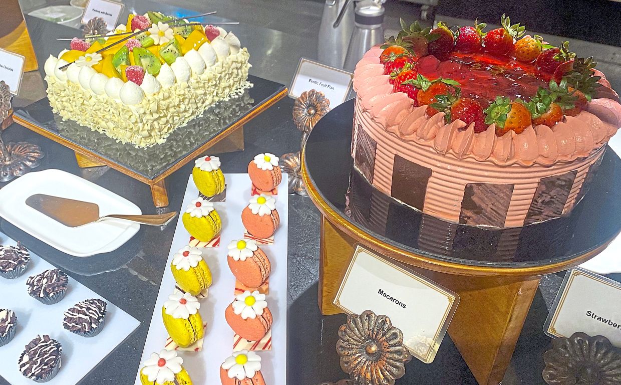 A variety of cakes and sweet treats at the dessert counter.