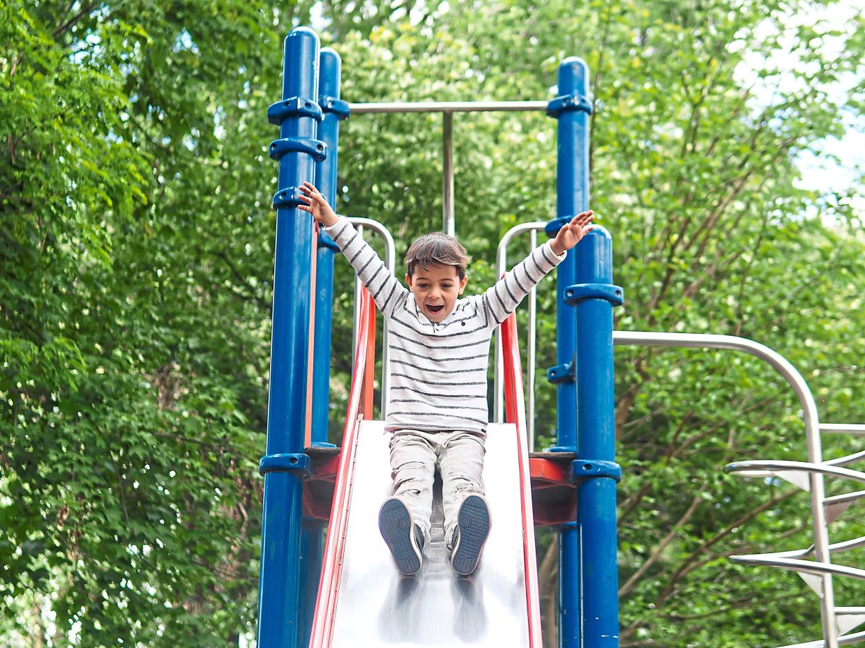 Teach your child to go down the slide feet first to avoid head injuries and to make sure anyone in front of them is all the way down before they go. Photo: Freepik