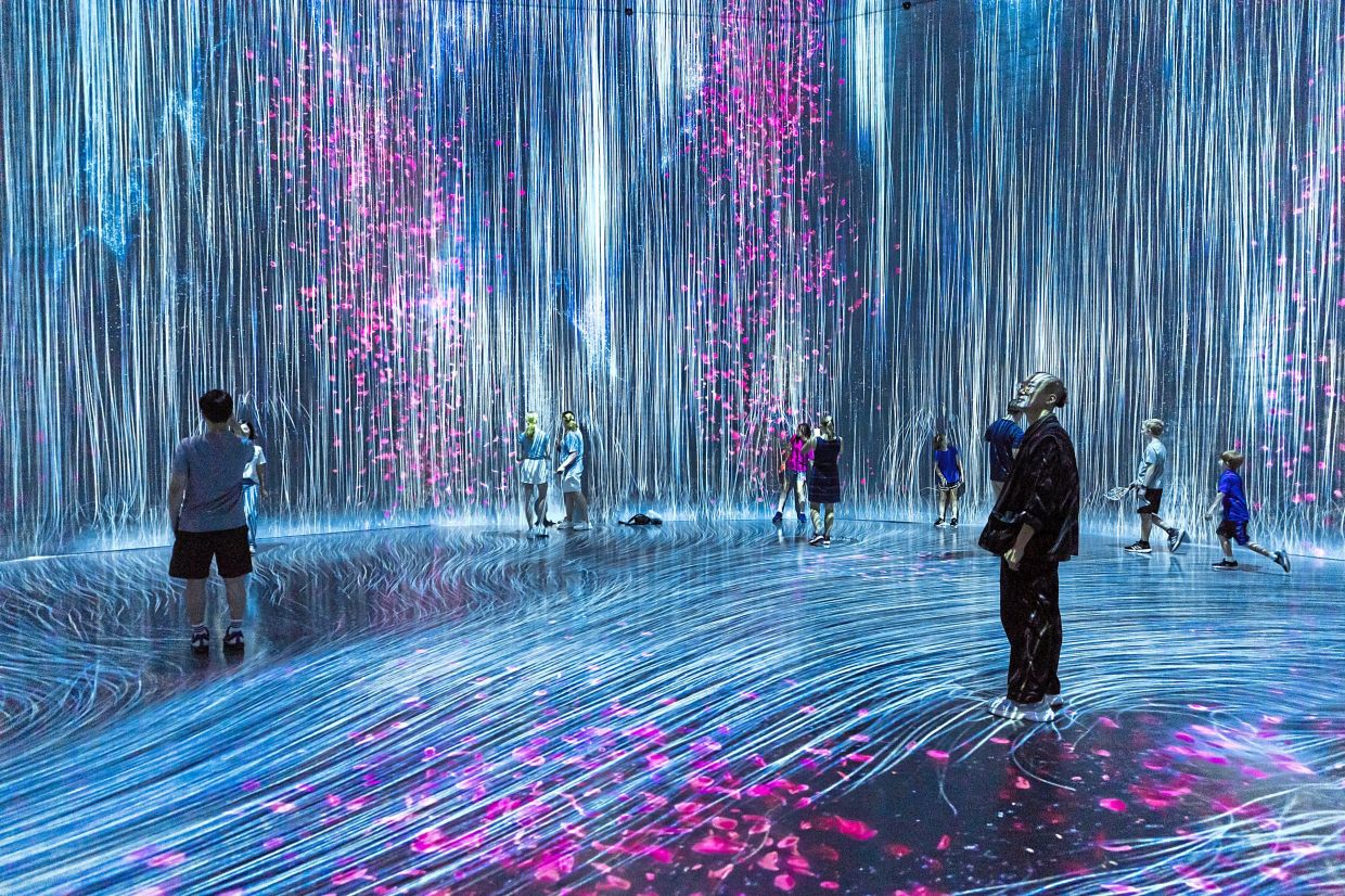 Visitors at teamLab Borderless at the Mori Building Digital Art Museum in Tokyo. The group’s psychedelic sensory playgrounds of light, sound, stars, bubbles, birds and more are expanding around the globe, dazzling millions of visitors a year. — Shiho Fukada/The New York Times