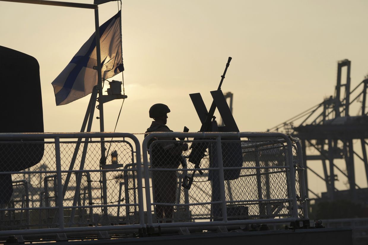 A member of the personnel stands guard on the bow of Russian Navy corvette Hero of the Russian Federation Aldar Tsydenzhapov, which is docked at Tanjung Priok Port during a port visit in Jakarta, Indonesia, Tuesday, June 3, 2025. -- AP Photo/Tatan Syuflana