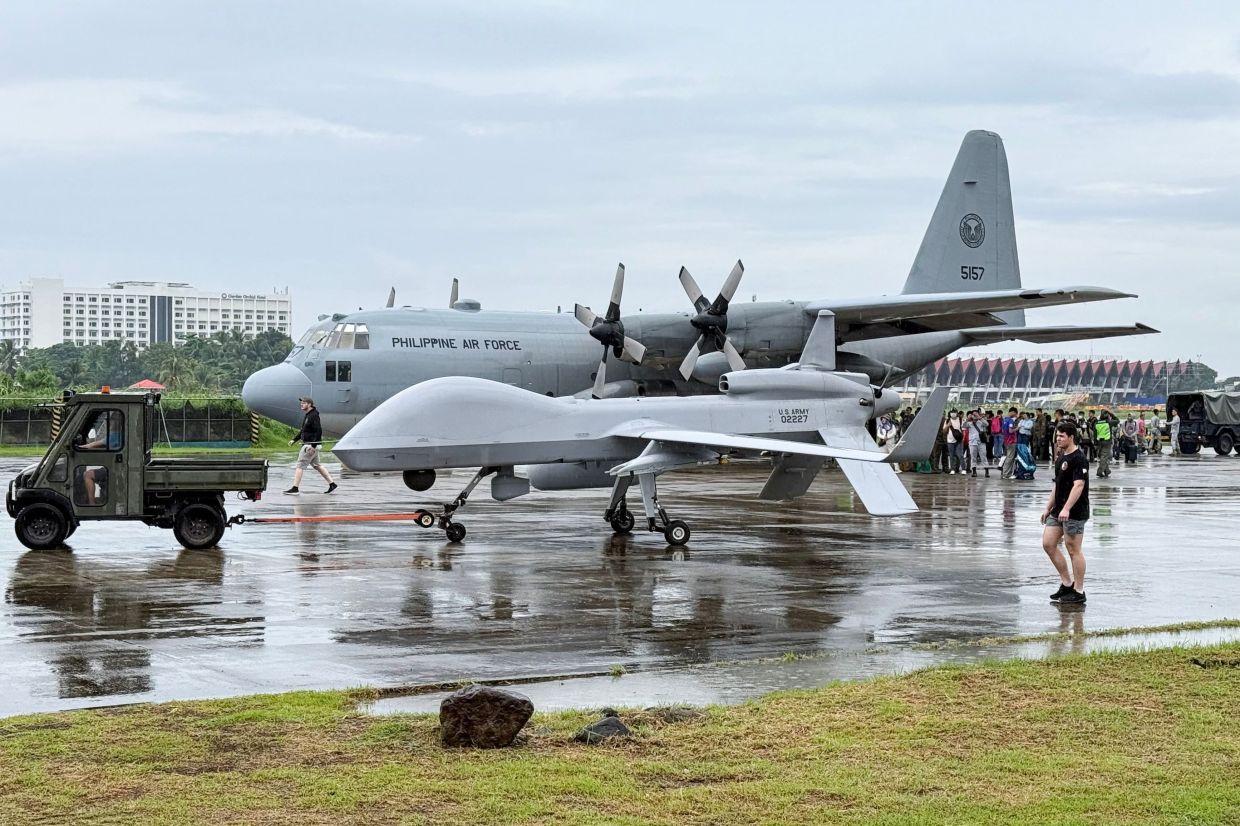 A US army General Atomics MQ-1C Gray Eagle UCAV taxis past a Philippine Air Force cargo plane at Zamboanga International Airport in southern island of Mindanao on Tuesday, June 3, 2025. -- Photo by TED ALJIBE / AFP