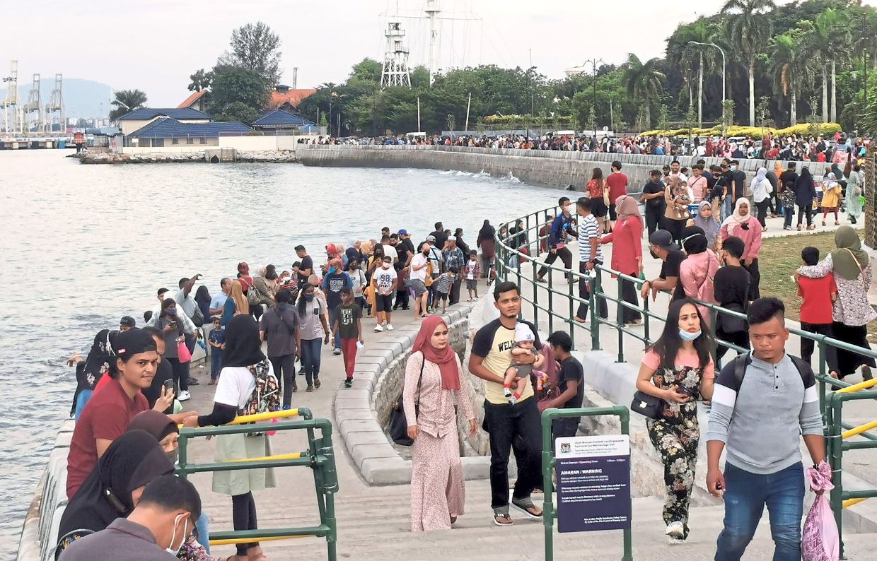 Breezy trail: Visitors enjoying their walk at the Esplanade in George Town, Penang.