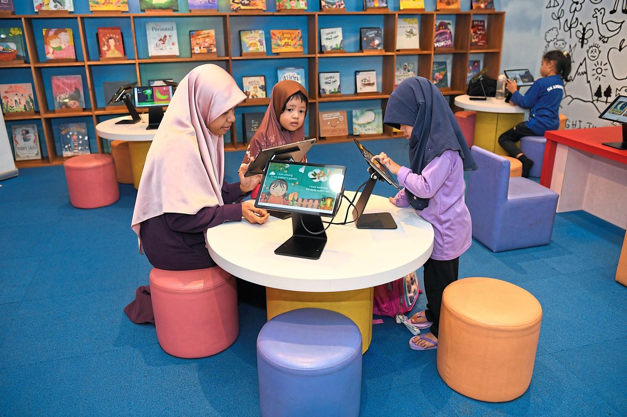 Children playing with the tablets provided in the library.