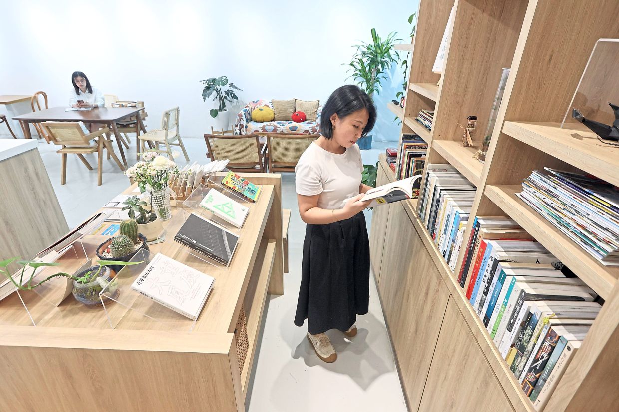 Low creates moments in the day to read. She usually reaches for a book when the traffic at her cafe slows down. The Star