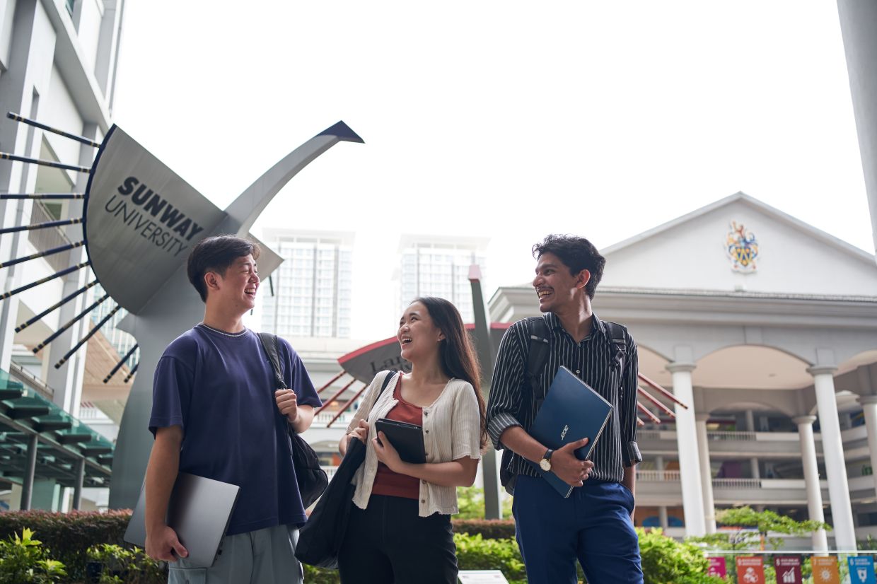 Sunway University students sharing a cheerful moment between classes, surrounded by an inspiring campus atmosphere.