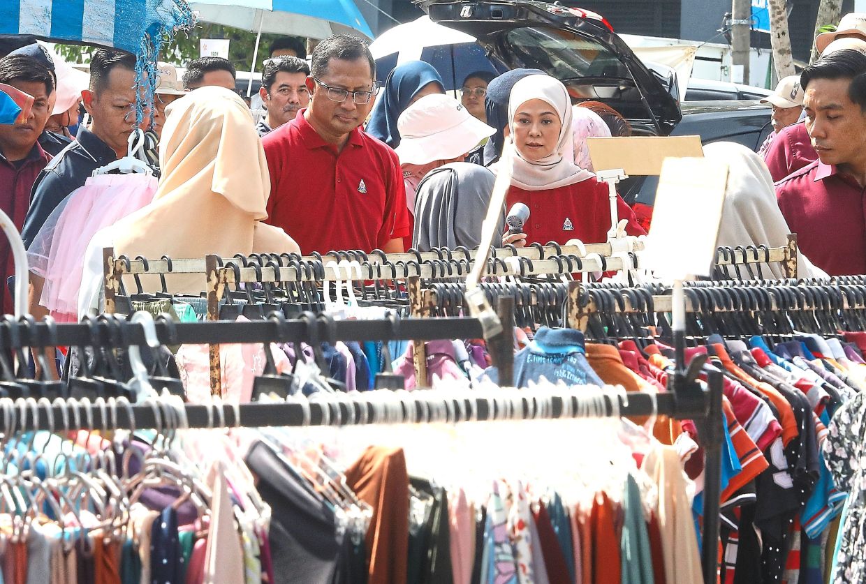 Tengku Permaisuri Norashikin, accompanied by the Petaling Jaya mayor, visiting the booths set up at the Kota Damansara car boot sale.