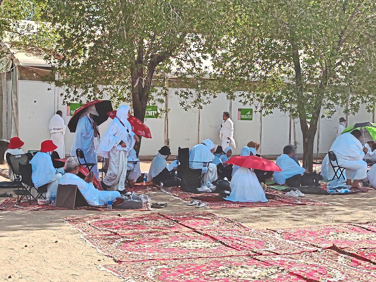 Enjoying the shade amid Mecca’s high temperatures. Friendly groups quickly formed among the pilgrims. — ZAKIAH KOYA/The Star
