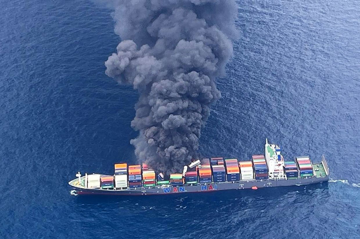 This handout photograph taken and released on Monday, June 9, 2025 by the Indian Coast Guard (ICG) shows smoke billowing from a cargo vessel that caught fire off Beypore coast in India's Kerala state. India deployed coastguard aircraft and a warship on June 9, after a Singapore-flagged container ship caught fire off the southern coast, the defence ministry said. -- Photo by Indian Coast Guard (ICG) / AFP