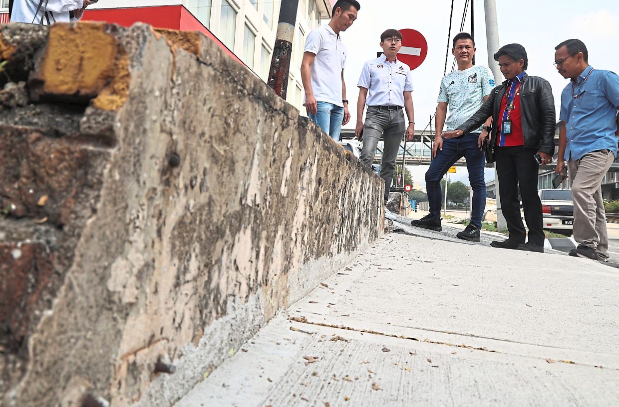 Lai (left) with DBKL engineering department officials during a site visit to Jalan Kepong. — Photos: AZMAN GHANI/The Star 
