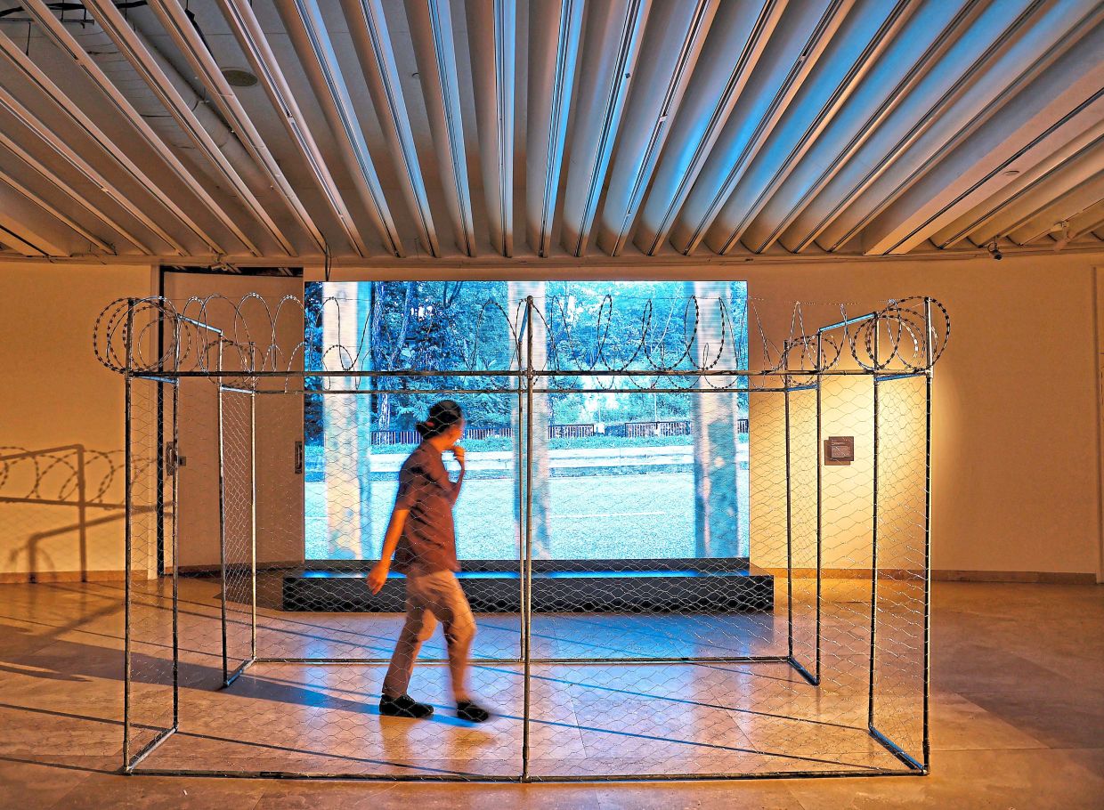 A gallery visitor walks through Zulkefli’s new installation titled ‘Anything But Prison’, which has an accompanying five-minute video. Photo: The Star/Muhamad Shahril Rosli