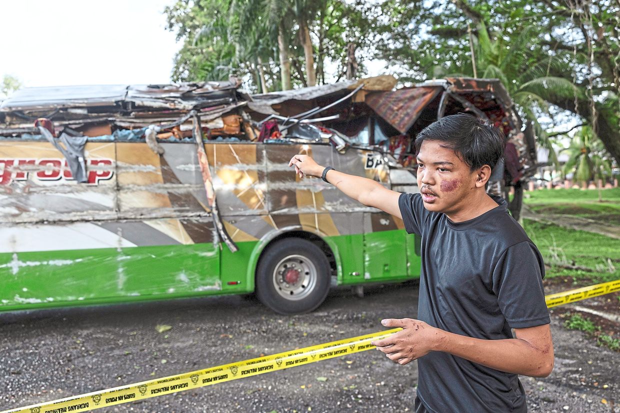 Traumatic scene: Abdul Wafiy recounting what he encountered during the fatal accident that claimed the lives of 15 UPSI students and injured 27 others, in front of the Gerik district police headquarters. — Bernama