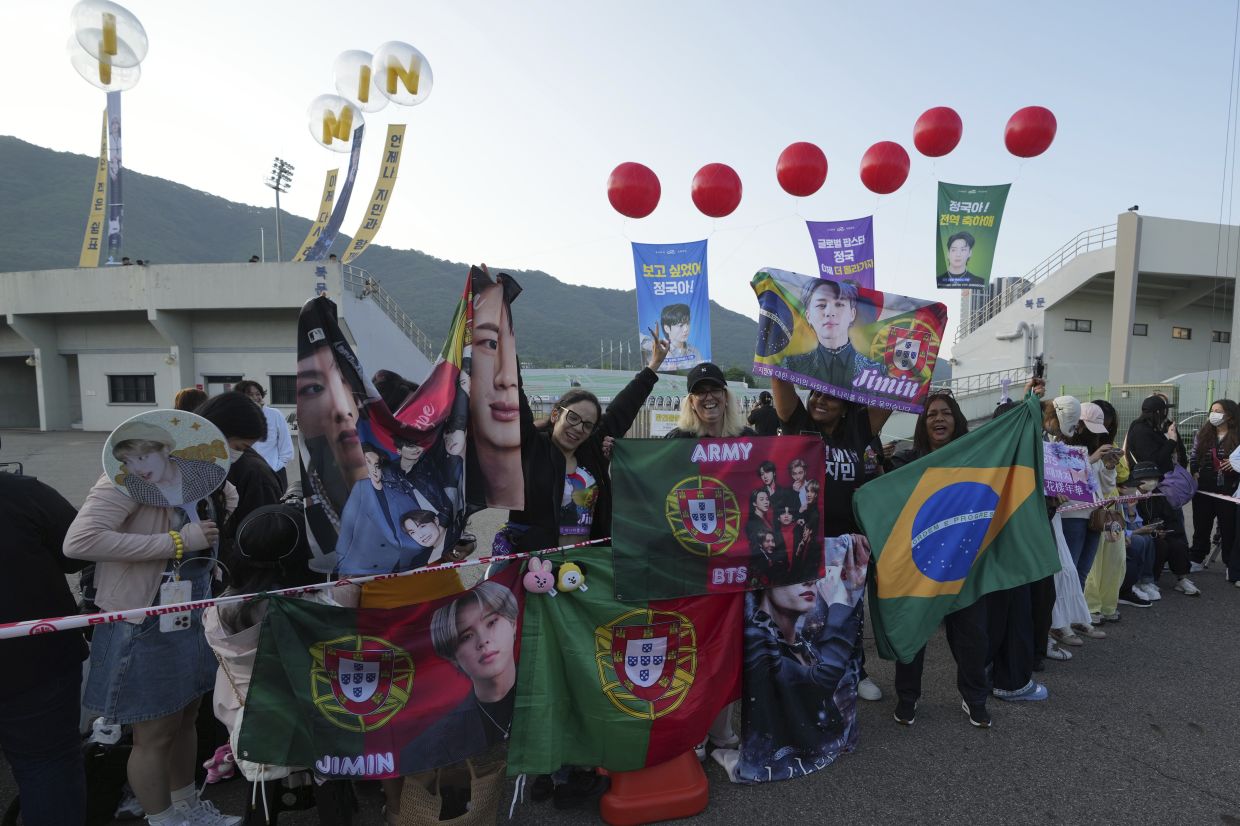 Fans waiting for the arrival of K-pop band BTS members Jimin and Jung Kook in Yeoncheon on June 11. - AP