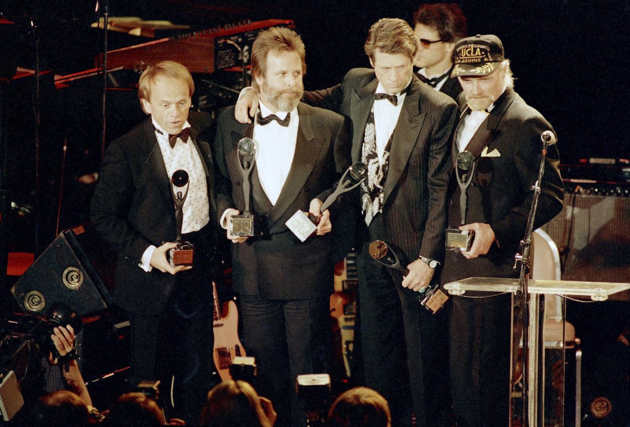 The Beach Boys, from left, Al Jardine, Carl Wilson, Brian Wilson and Mike Love, hold their trophies after being inducted into the Rock 'n' Roll Hall of Fame in New York, Jan. 21, 1988. (AP Photo/Ron Frehm, File)