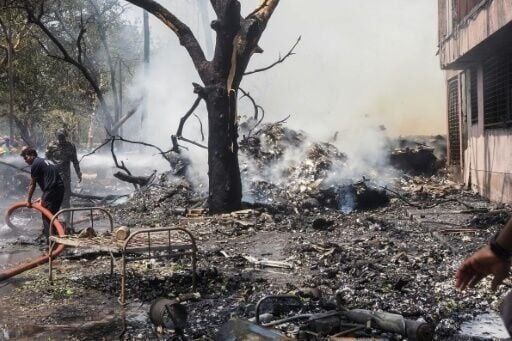 Firefighters work at the site where Air India Flight 171 crashed in Ahmedabad, India. 