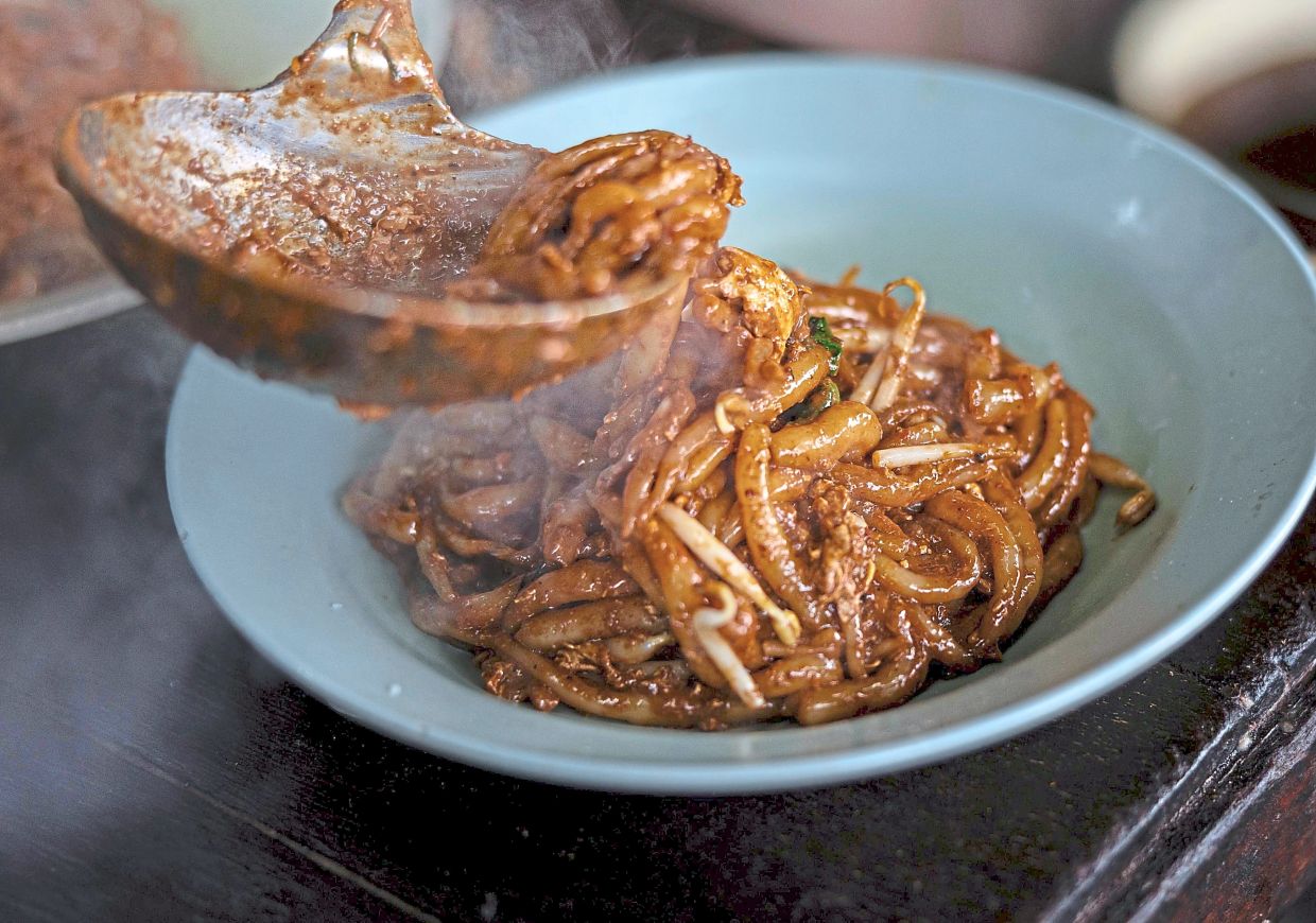 Mi Tikus are short laksa noodles stir-fried with onions, eggs, prawns and soy sauce.