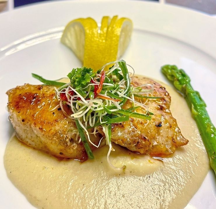 Grilled fillet of wild sea bass on a bed of fennel and asparagus cream.