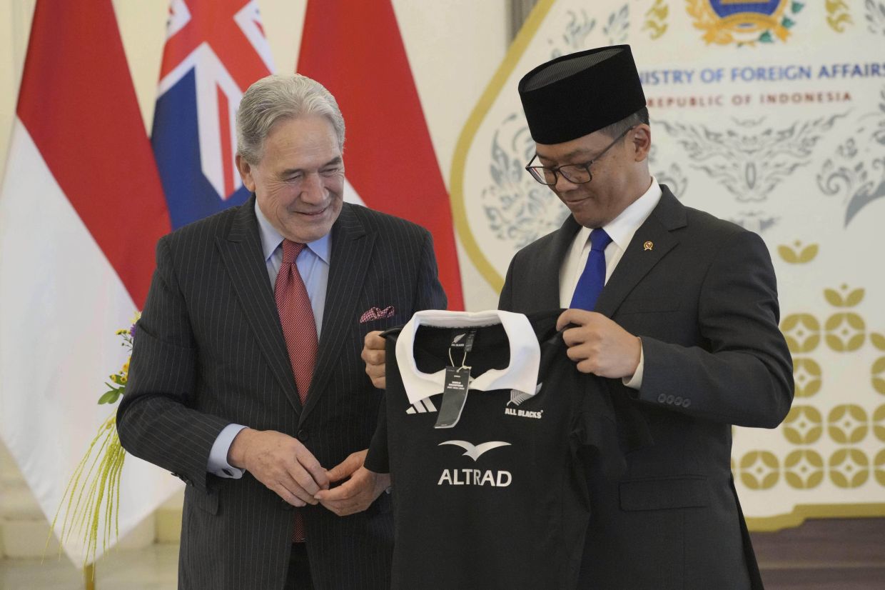 New Zealand's Foreign Minister Winston Peters, left, presents an All Blacks rugby jersey to his Indonesian counterpart Sugiono as they exchange souvenirs during their meeting in Jakarta, Indonesia, Friday, June 13, 2025. -- AP Photo/Achmad Ibrahim