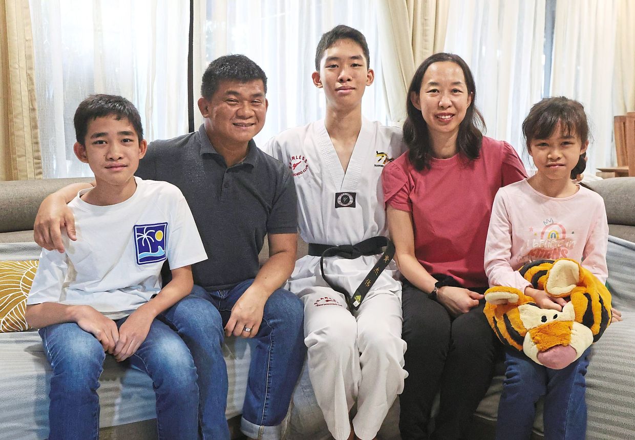 Dr Wong (second from left) decided to leave the medical profession to help his son Ryan (centre) after he was diagnosed with autism. Others in the photo are (from left) Dylan, Lim and Hayley.
