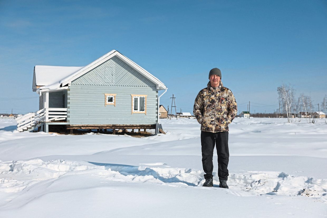 Poselsky showing his house which he built last year in Churapcha. It is surrounded by 20 mounds and hollows. — AFP
