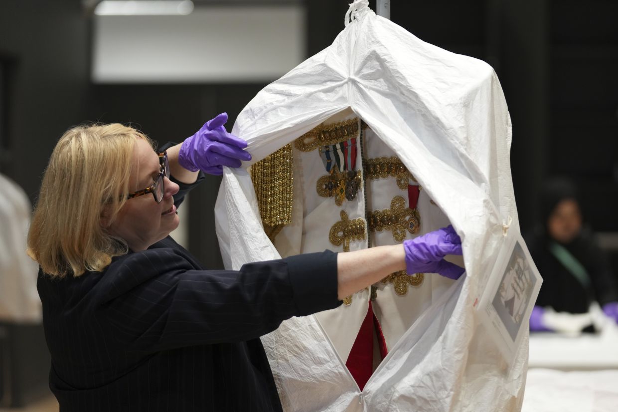 Kate Parsons, Director of Collections Care and Access, shows a costume worn by Elton John on his 1981 world tour, at the V&A Storehouse in London. Photo: AP 