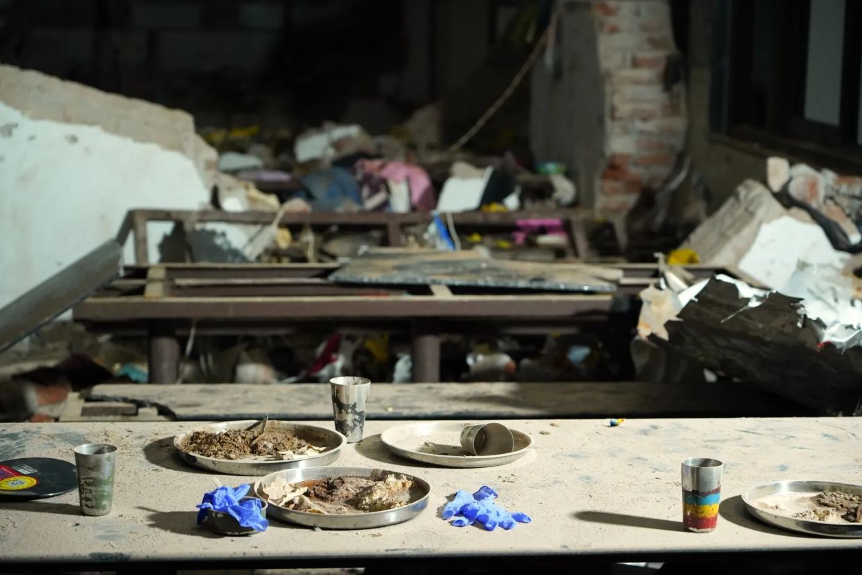 Plates with food at a dining hall of the medical school hostel at the crash site. - Photo: Bloomberg