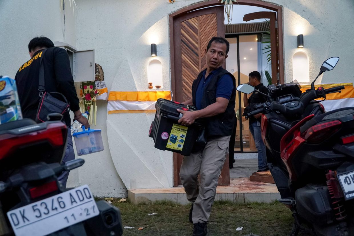Local police officers conduct forensic examinations at the scene after two Australian nationals were shot in Munggu village, on Indonesia resort island of Bali on Saturday, June 14, 2025. One victim, Zivan Radmanovic, 32, was confirmed dead at the scene, while the other, Sanar Ghanim, 35, sustained a gunshot wound and was taken to hospital, according to the local police. -- Photo by Dicky Bisinglasi / AFP