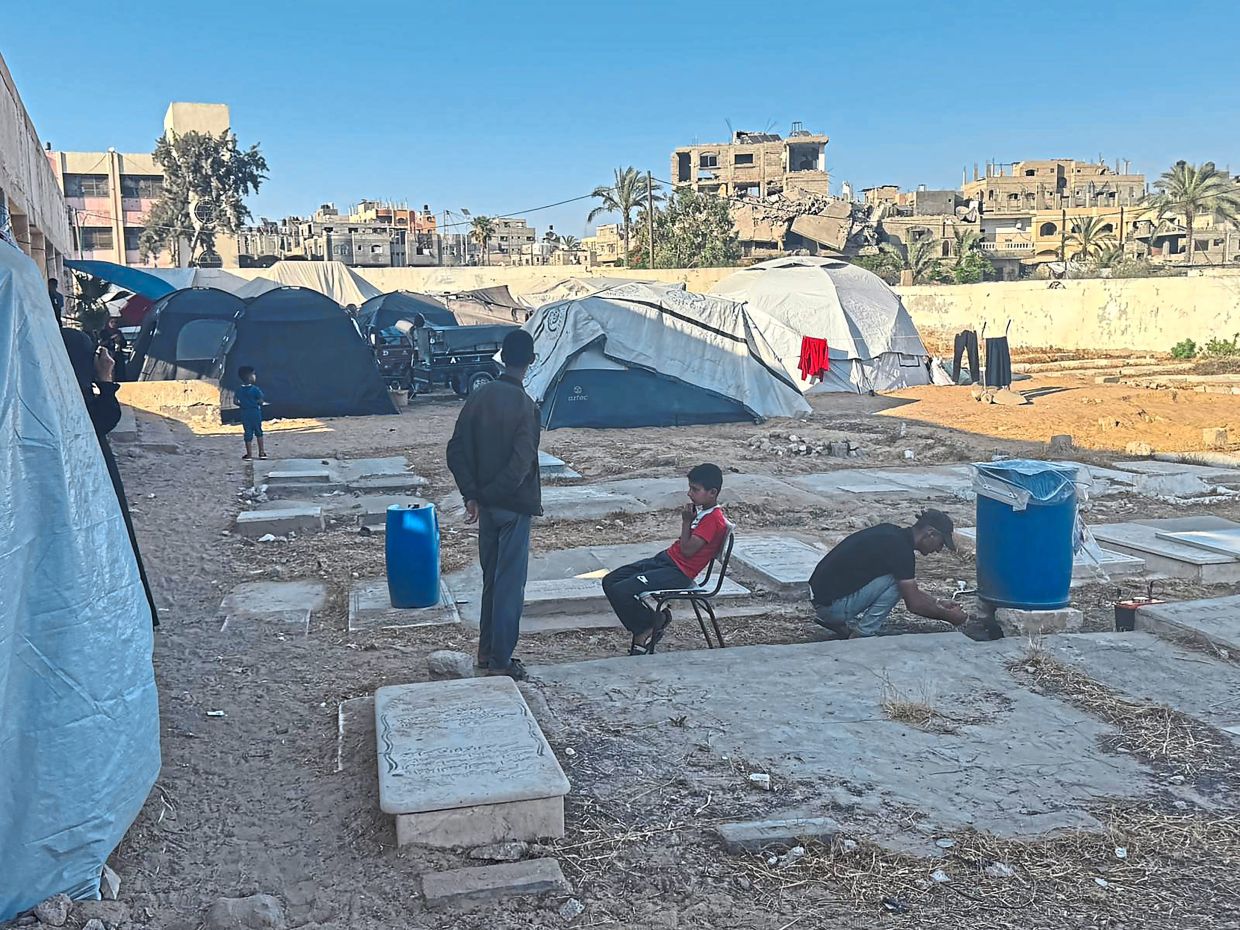 The graveyard near where the al-Najjar family now lives in a tent in Khan Younis. — Bilal Shbair/The New York Times