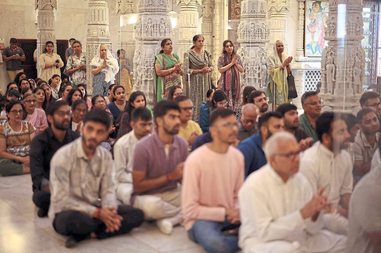 Worshippers attending a memorial service for the crash victims at Neasden Temple in northwest London in Britain. —AFP