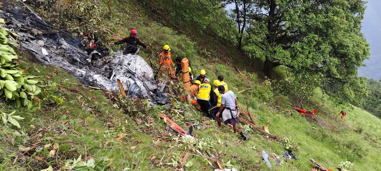 Members of rescue teams work at the site of a chopper crash in the Gaurikund area of the northern Indian state of Uttarakhand, India, June 15, 2025. - Photo: State Disaster Response Force (SDRF) Uttarakhand/Handout via Reuters