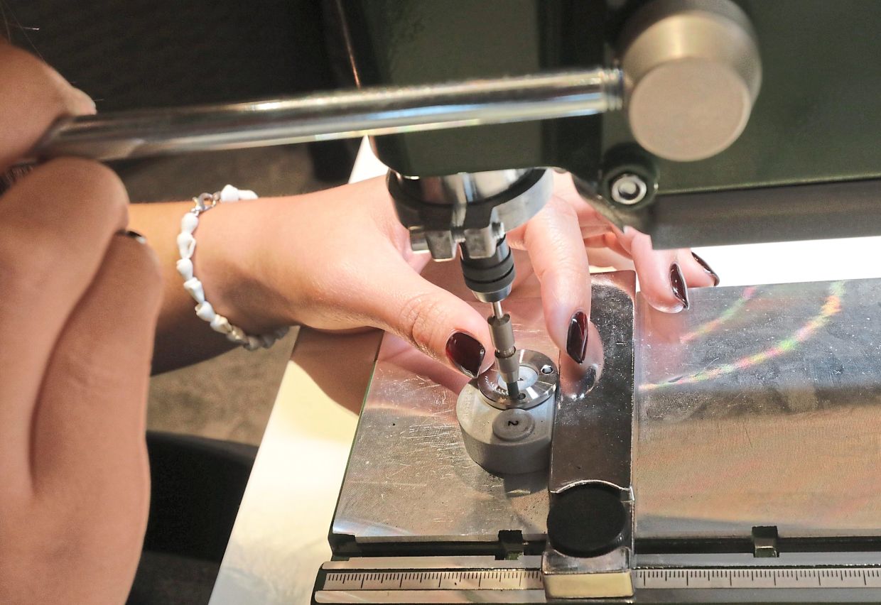 Looking into the process of black polishing a watch’s balance cock.