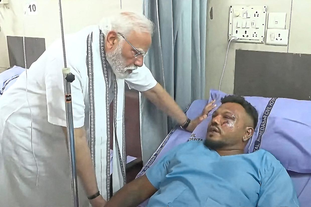 Checking in: India’s Prime Minister Narendra Modi meeting Ramesh at a hospital in Ahmedabad. — AFP/AP 