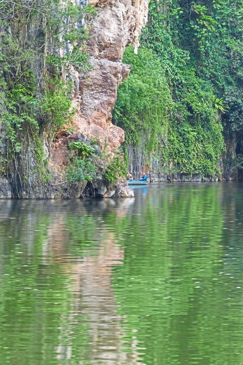 Silhouetted by stone and silence, a raft tucks into the edge of the gorge, where jungle and rock embrace, and time feels suspended above water.